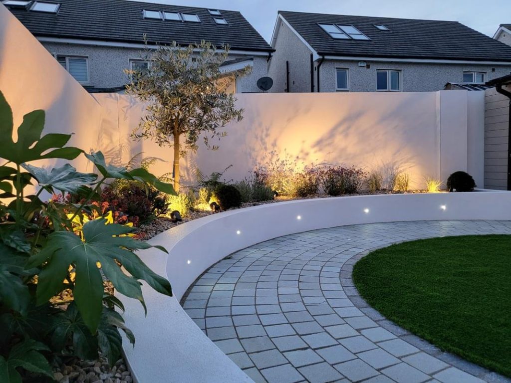 Curved Raised Flowers bed with low maintenance flowers and a beautiful Olive Tree
